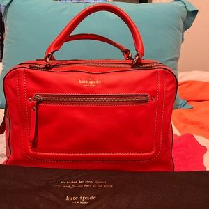 Kate Spade orange leather zippered-top bag with double handles.